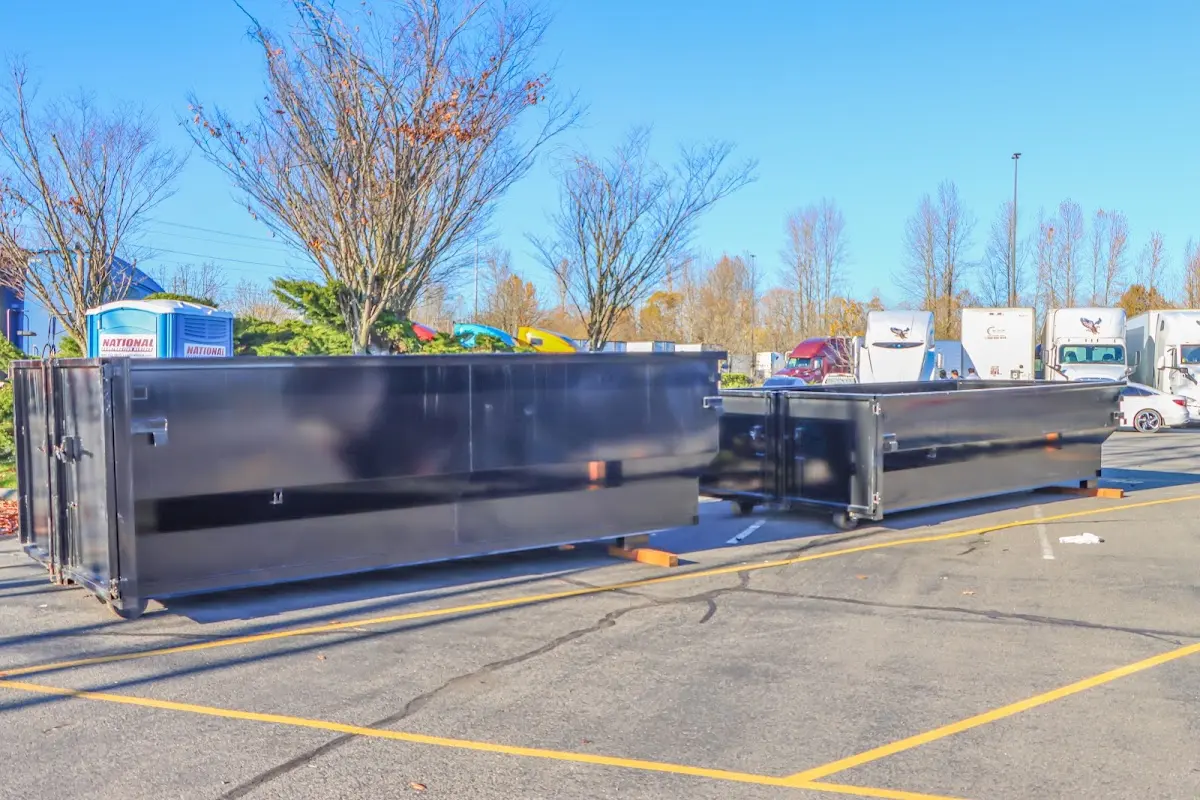 Professional dumpster rental service with roll-off container on residential driveway in Three Oaks